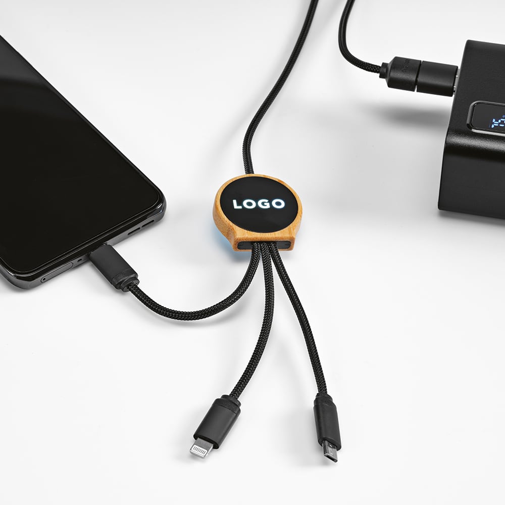 A 5-in-1 charging cable with a bamboo connector, featuring a backlit logo, black and grey cords, and connected to a smartphone.