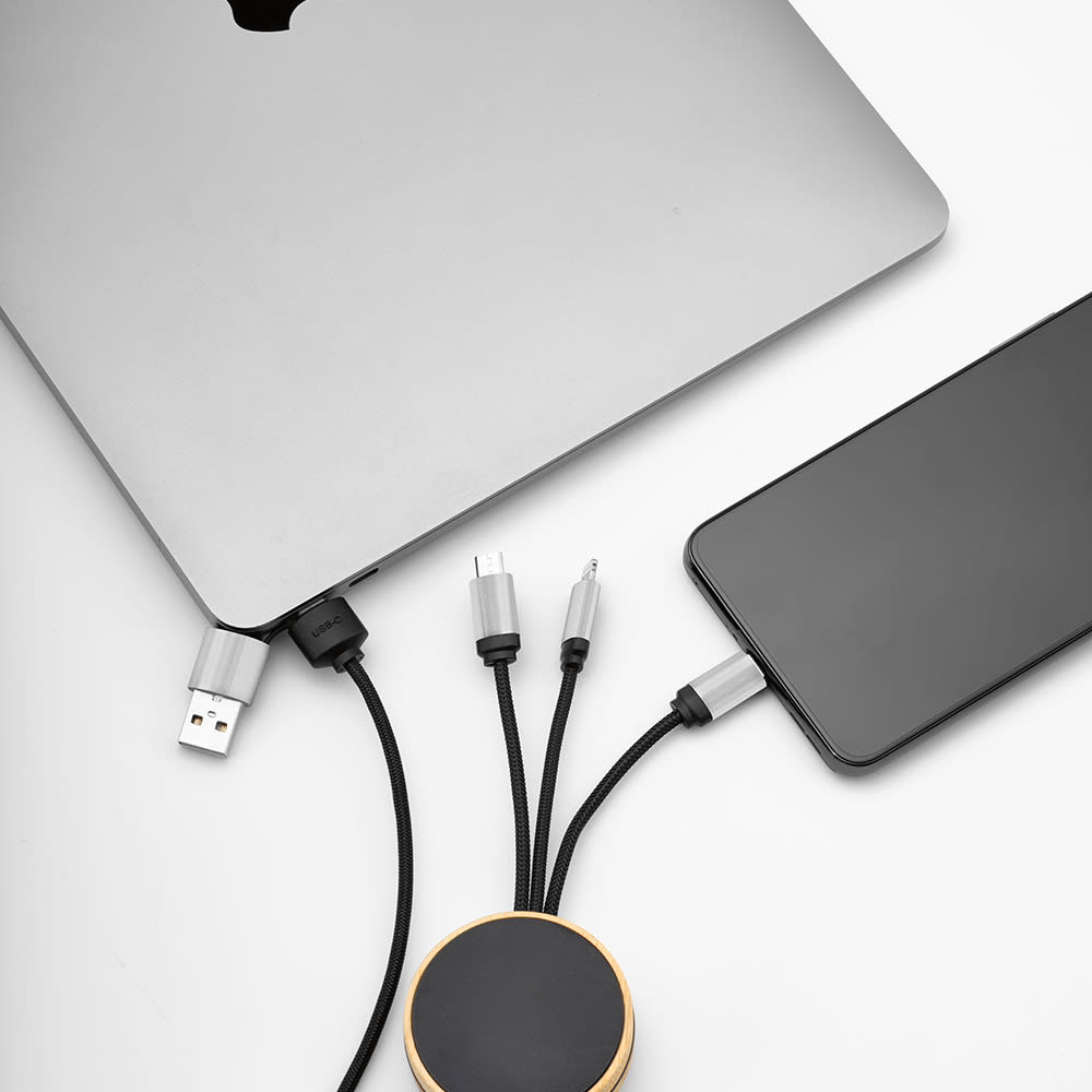 A bamboo and rPET 5-in-1 cable in black connected to a laptop and phone, featuring a backlit logo.