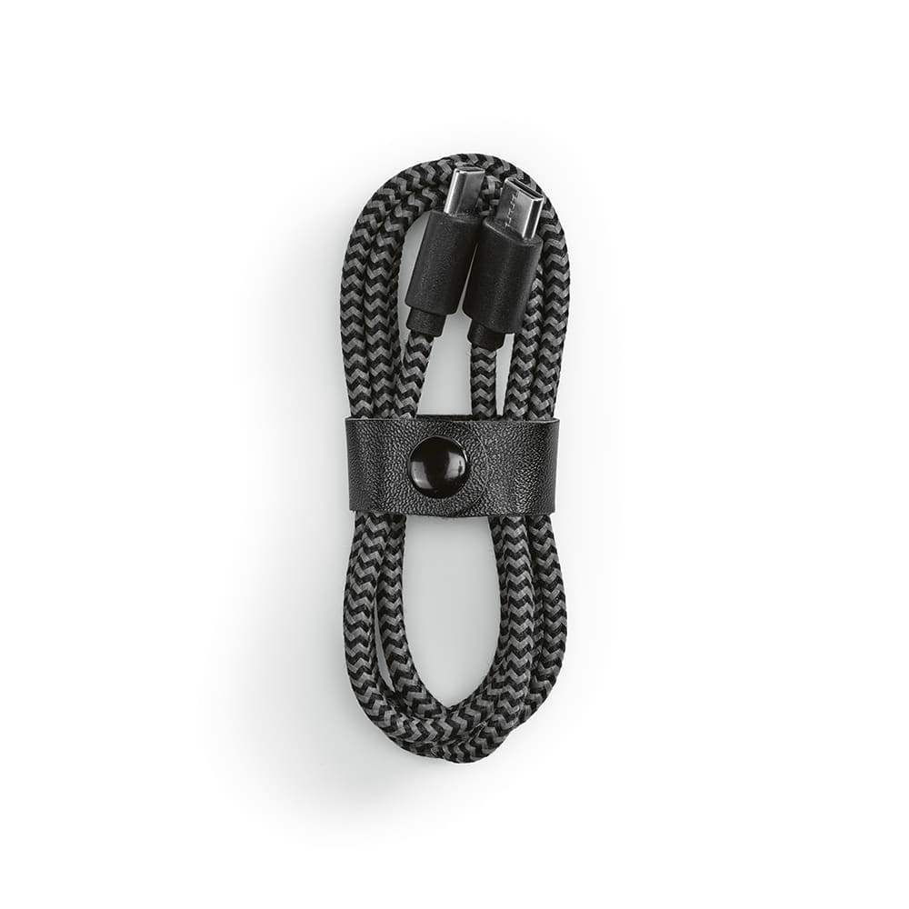 A black and grey braided USB-C to USB-C cable, neatly coiled and secured with a leather strap, with a logo on it.