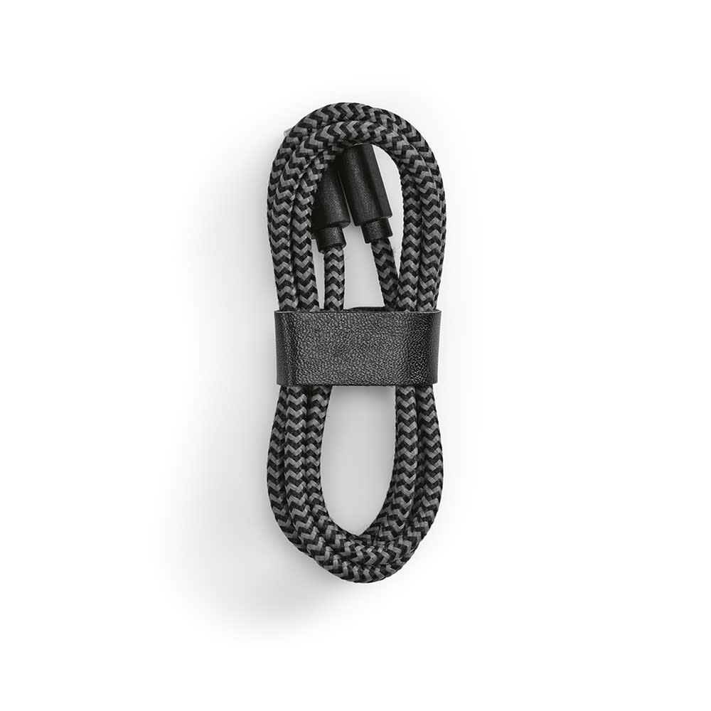 A black and grey braided USB-C to USB-C cable, neatly coiled and secured with a strap.