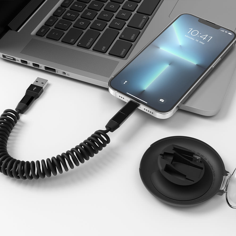A coiled USB fast charging cable is connected to a smartphone and a laptop. The cable is housed in a compact organiser.