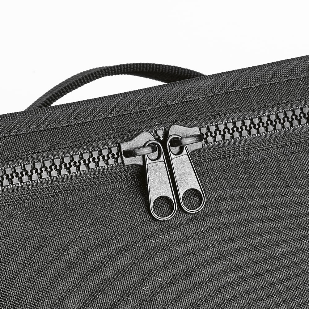 A grey cooler bag featuring thermo-injected zippers and a textured surface. Branding is visible on the exterior.