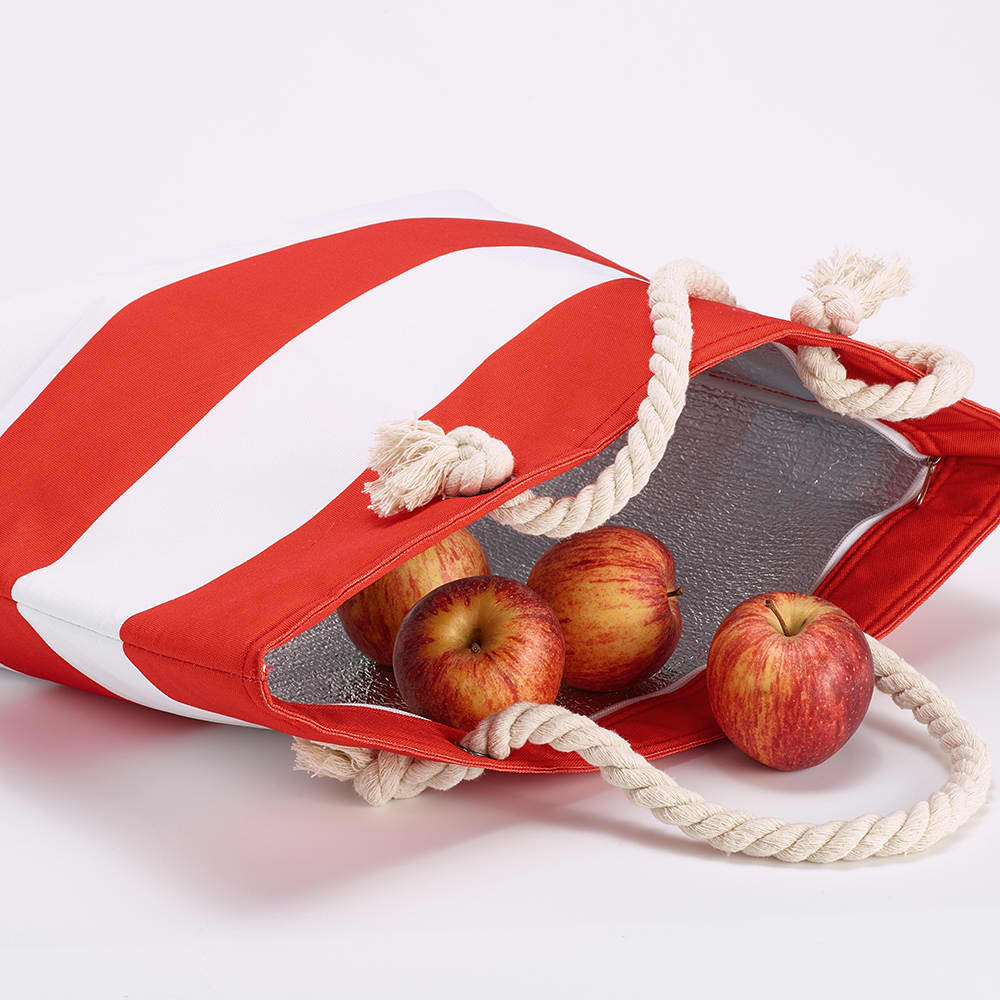 A red and white striped cooler bag with recycled cotton handles, containing several apples inside.