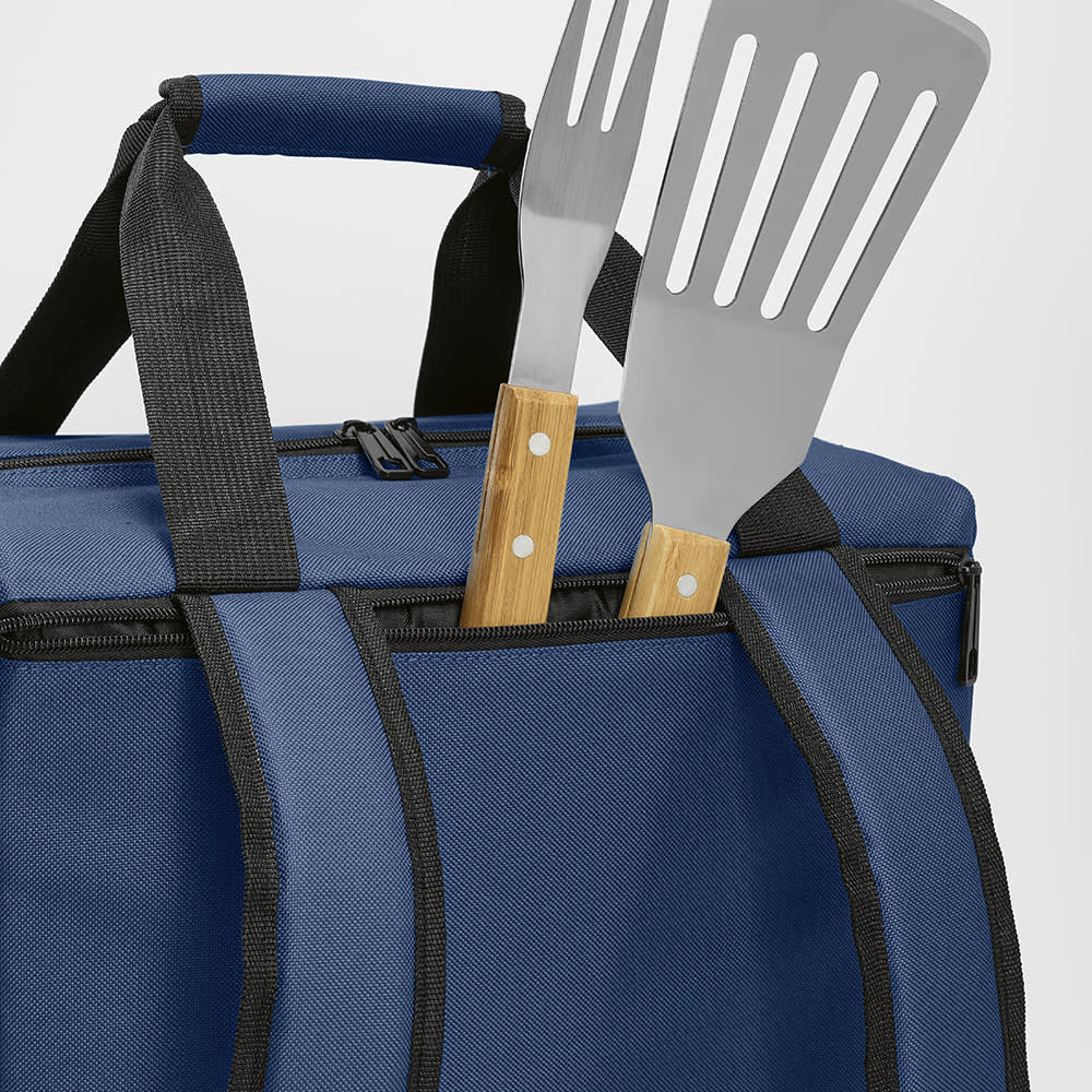 A navy blue cooler bag with a front pocket and two side pockets, featuring two spatulas with wooden handles.