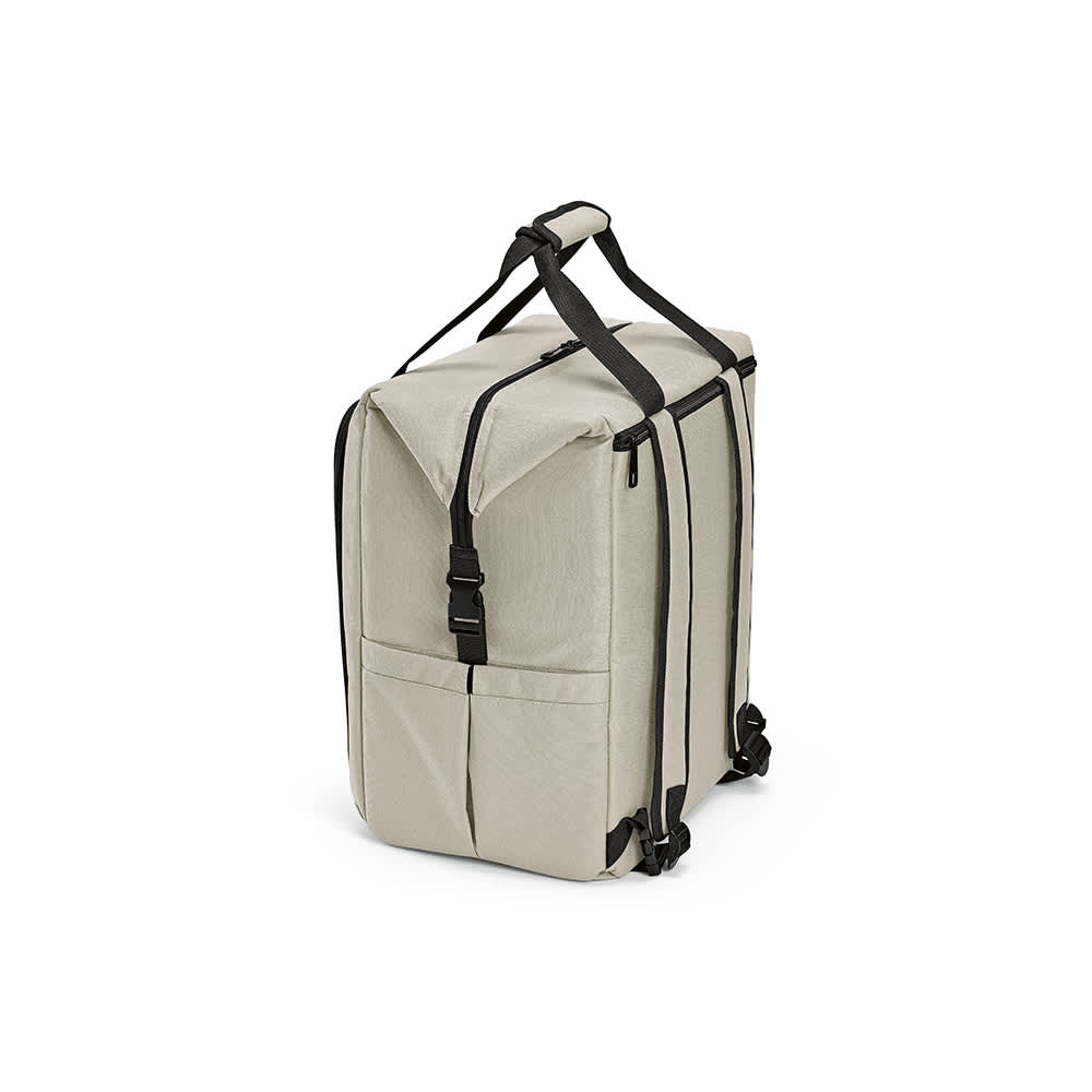 A beige cooler bag featuring a front pocket, two side pockets, and adjustable straps. It has a logo on the side.