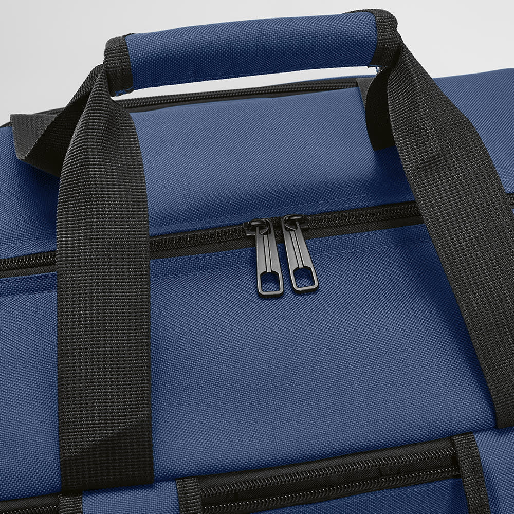 A blue cooler bag with a top handle, featuring a zip closure and side pockets. It has a logo.