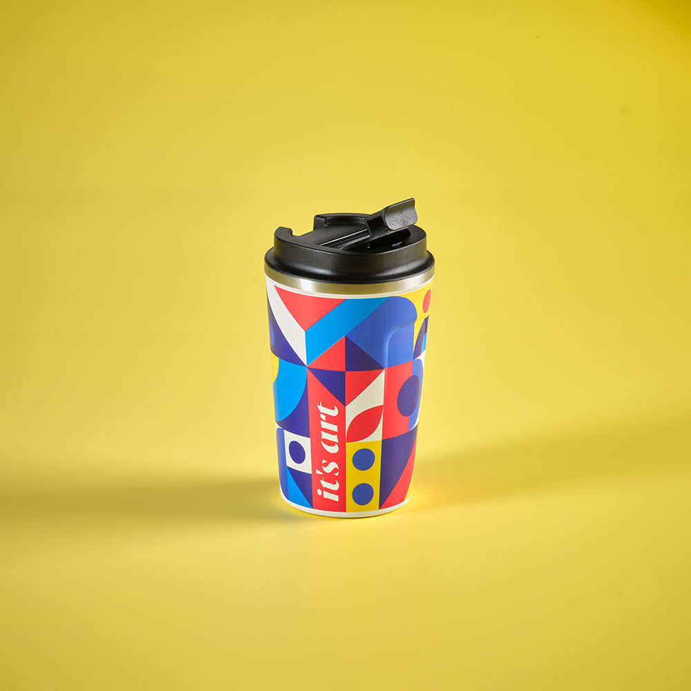 A drink bottle with a multicoloured geometric design, featuring a black lid and a logo.
