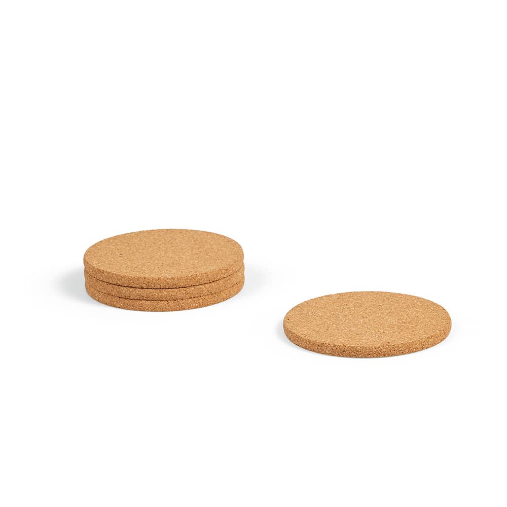Four round cork coasters stacked, with one coaster adjacent, featuring a natural cork colour and a smooth surface.