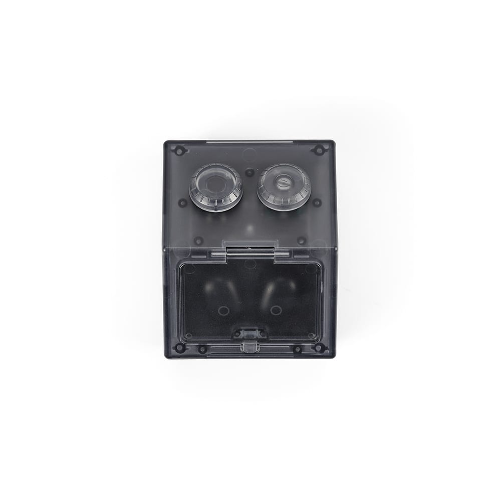 A black, transparent square container with two knobs on top and an open front panel. Features a simple, minimalist design.