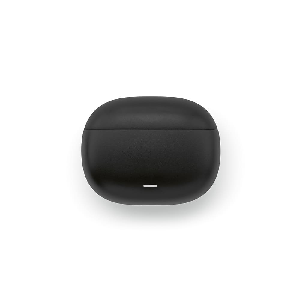 A black charging case for earbuds, with a smooth texture and small white indicator light on the front.