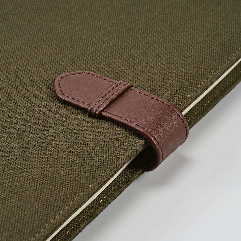 An olive green A4 folder with a brown rPU closure and a notepad inside. Features a logo.
