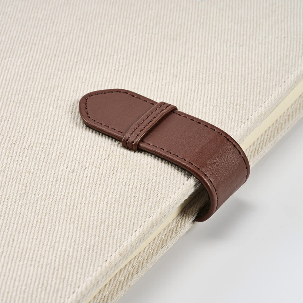 A cream A4 folder with a brown rPU closure, featuring a textured surface and a logo.