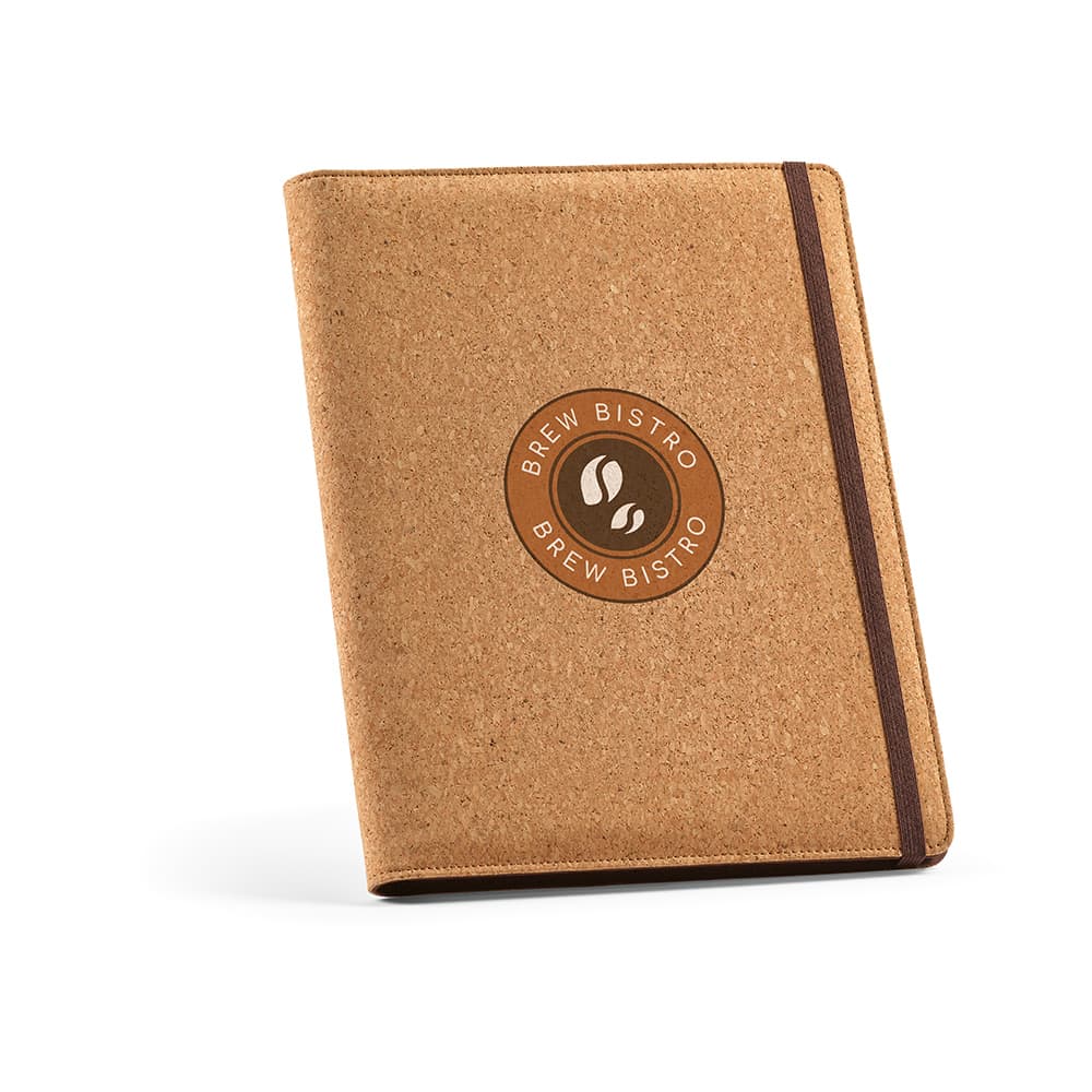 A cork A4 folder with a brown elastic closure and a circular logo on the front. Contains a 64 sheet notepad.