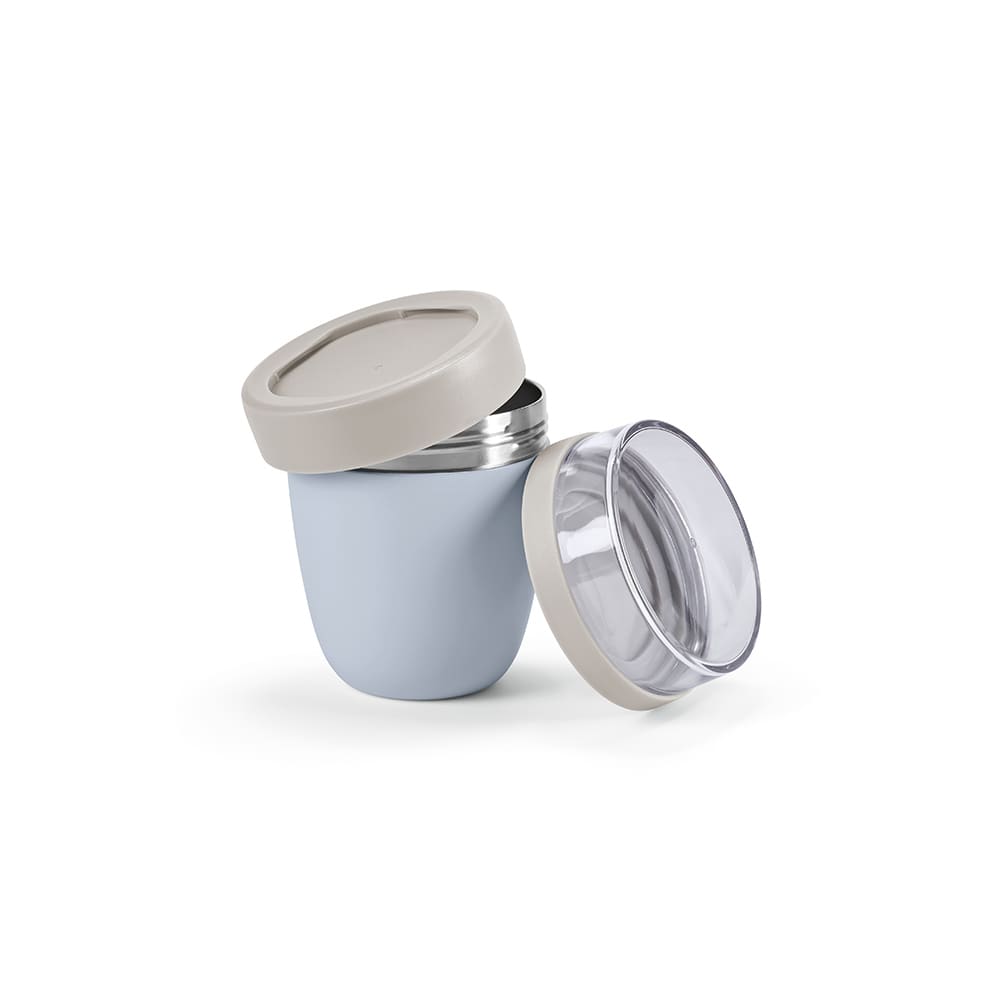 A food flask in light blue and beige, featuring two compartments and a transparent lid. It has a branding logo.