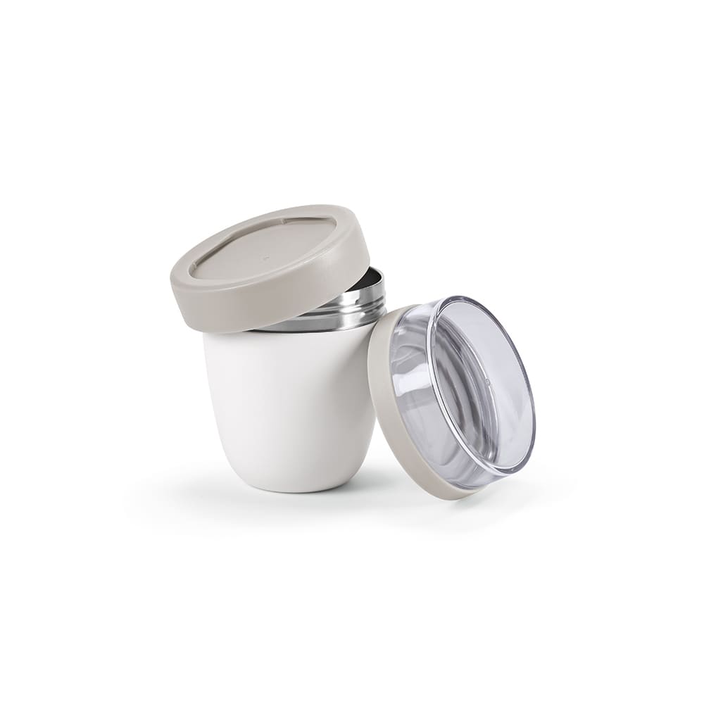A food flask featuring two compartments, with a white exterior and a grey lid. It has a transparent inner compartment.