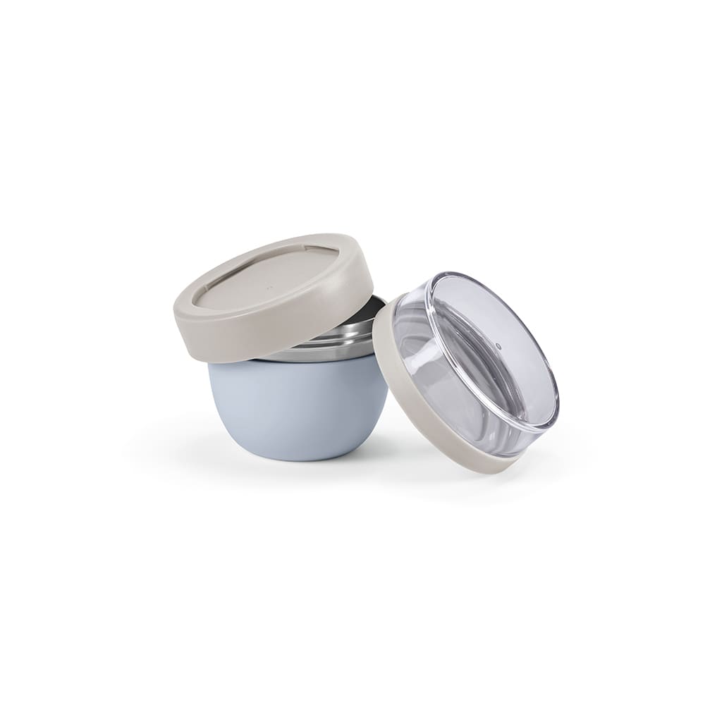 A food flask featuring a light blue exterior and two compartments, with a clear and beige lid. It has a logo.