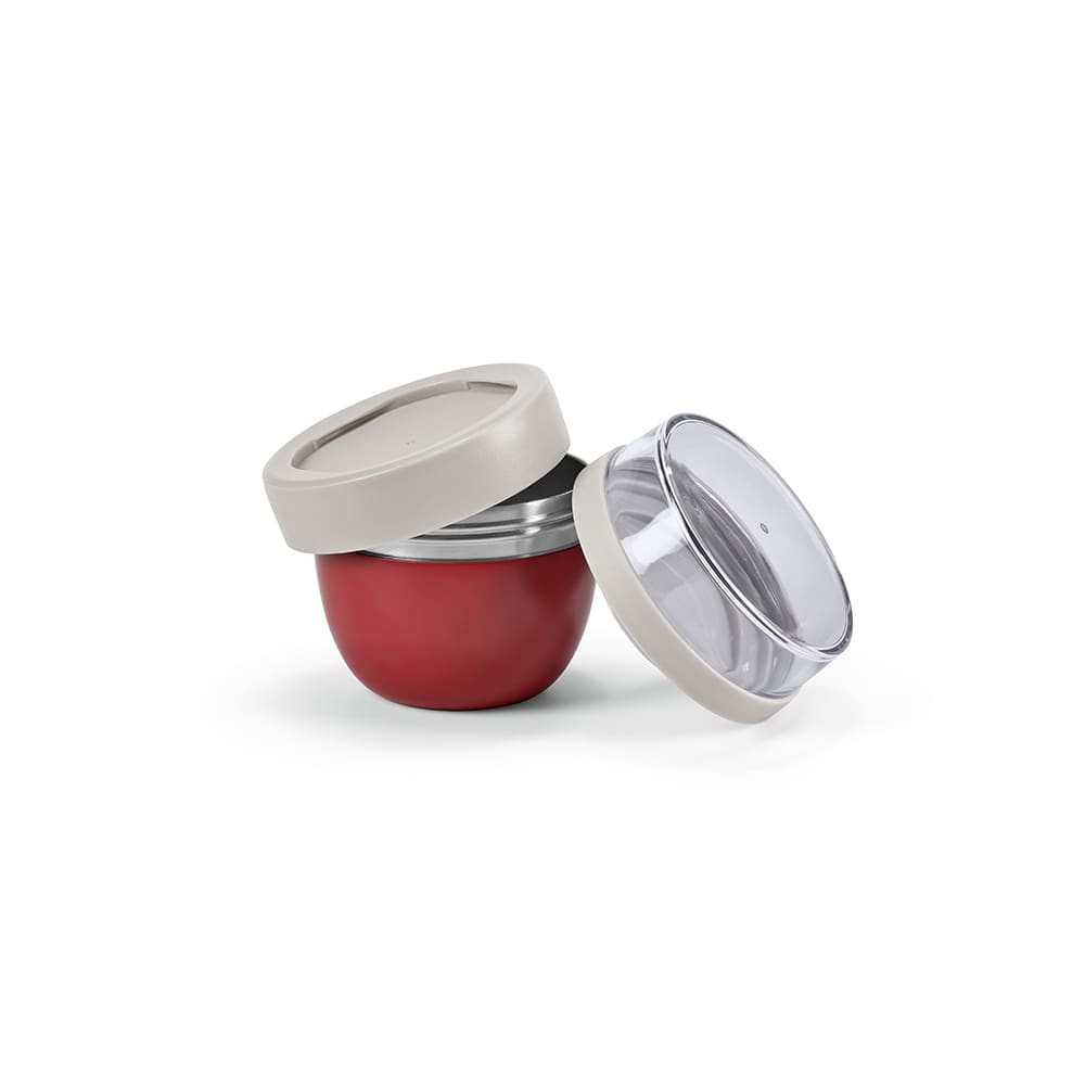 A drink bottle with a red base and a light-coloured lid, featuring two compartments and a transparent top.