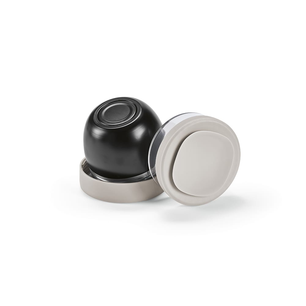 A food flask with two compartments, featuring a black upper section and a beige base, along with a logo.