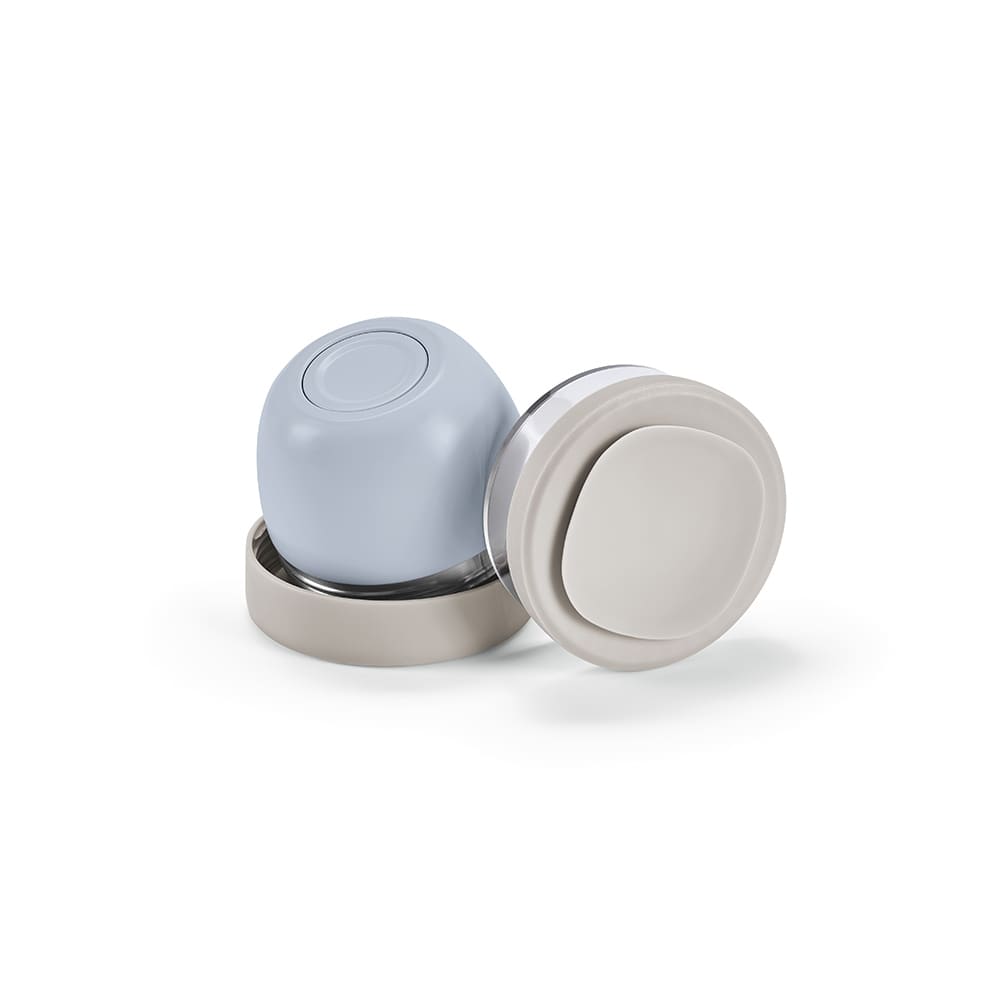 A food flask featuring two compartments, one light blue and one cream, with a sleek design and a logo.