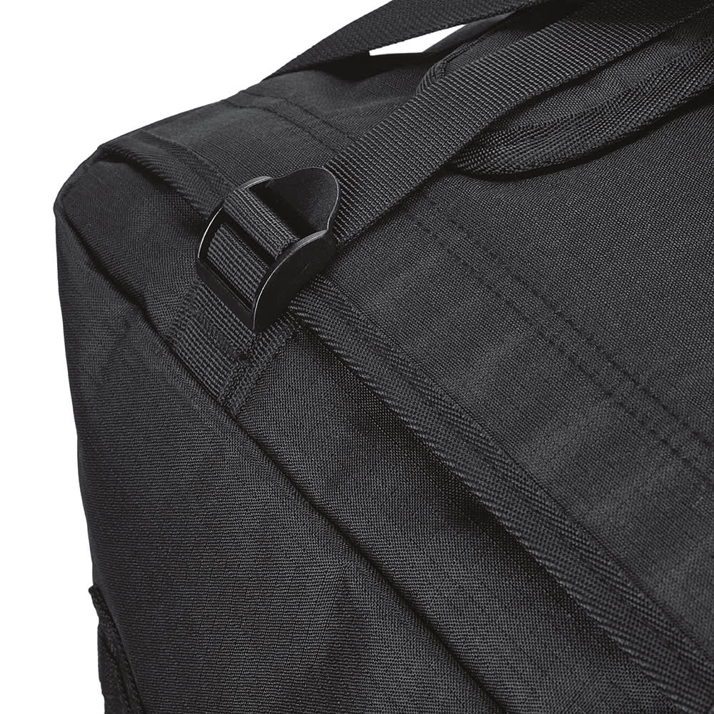 A black gym bag featuring adjustable straps and a textured fabric, with a logo visible on the side.