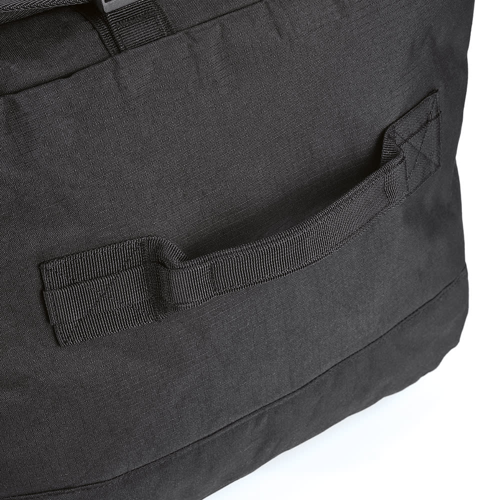 A large black gym bag featuring a sturdy handle and textured fabric. It includes reflective strips and a logo.