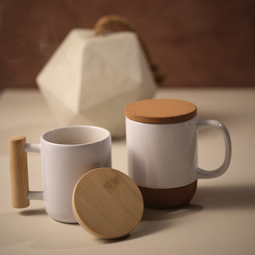A ceramic mug with a bamboo lid and handle, featuring a white exterior and a bamboo accent.