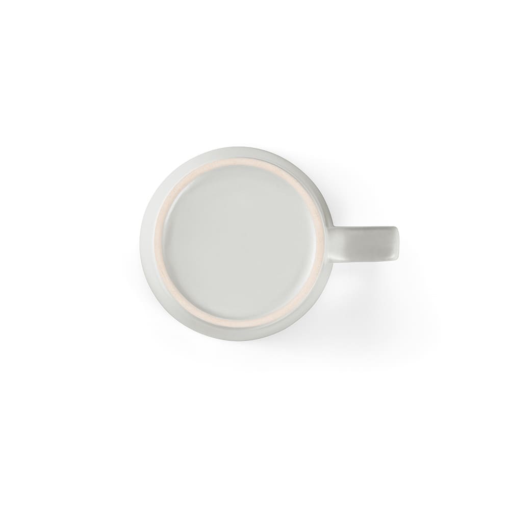 A ceramic mug with a matt finish, featuring a handle and a light colour. It has a smooth, round top.