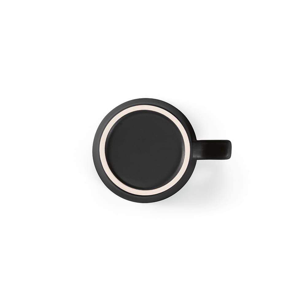 A ceramic mug with a matte black finish and a contrasting inner rim. It features a handle and a simplistic design.