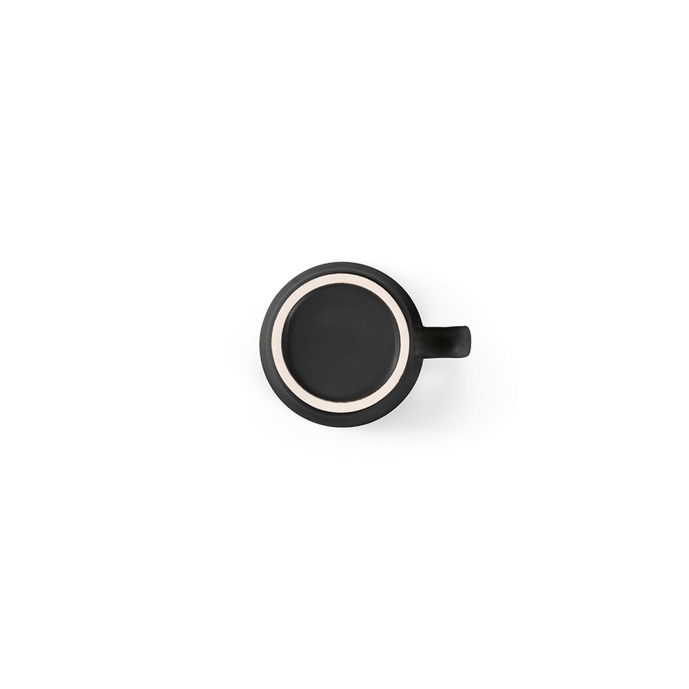 A ceramic mug featuring a matt black finish with a contrasting light-coloured rim and a single handle.