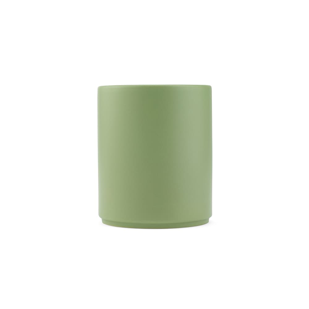 A ceramic mug with a matte finish in a soft green colour, featuring a simple design and a logo.