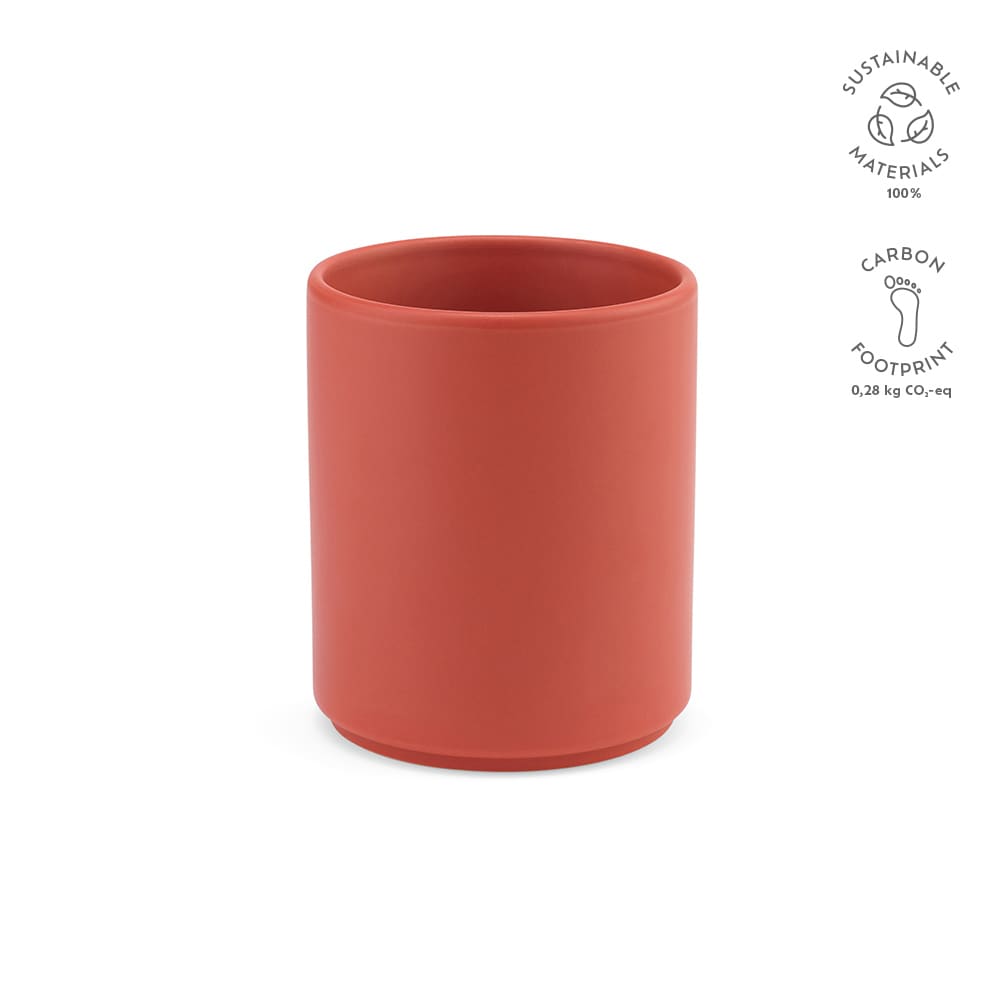 A ceramic mug in a matte terracotta finish with a simple cylindrical design and a logo.