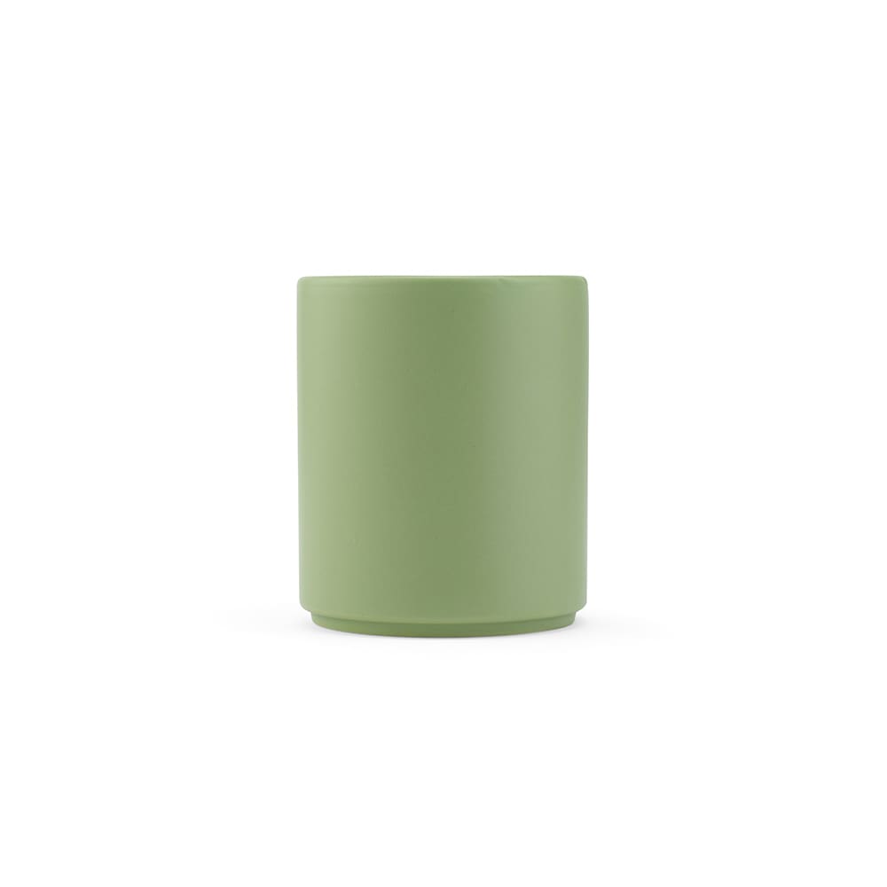 A ceramic mug in a soft green matte finish, with a simple cylindrical design and no visible branding.