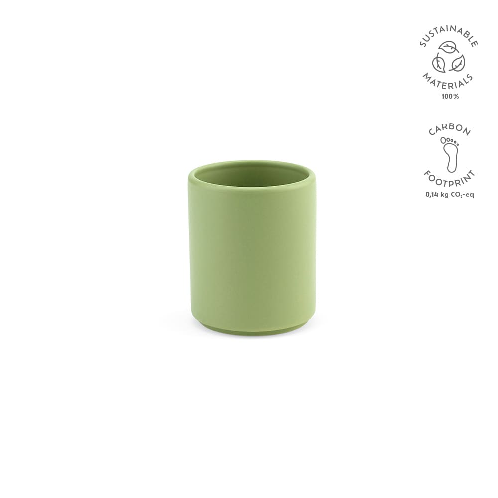 A ceramic mug in a soft green matte finish, featuring a logo and labelled with sustainable materials information.