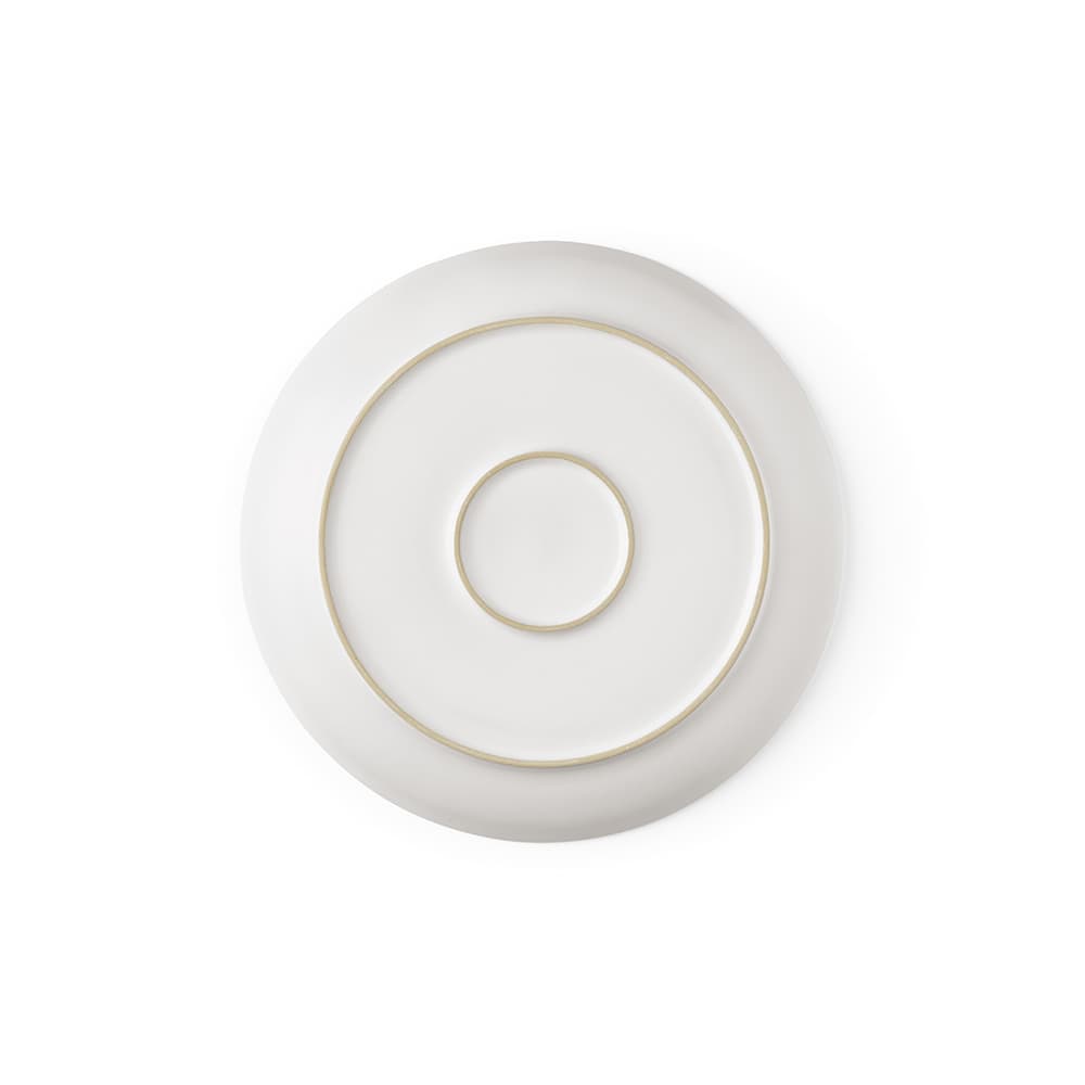 A ceramic dinner plate with a matte white finish and circular patterns, featuring a subtle gold rim. Made in Portugal.