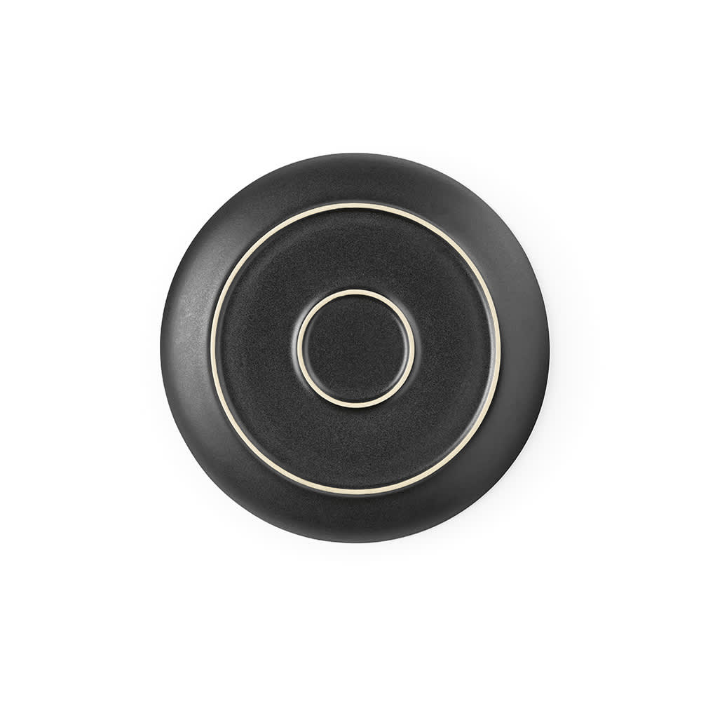 A matte black ceramic dinner plate with circular designs, made in Portugal. Features a logo.