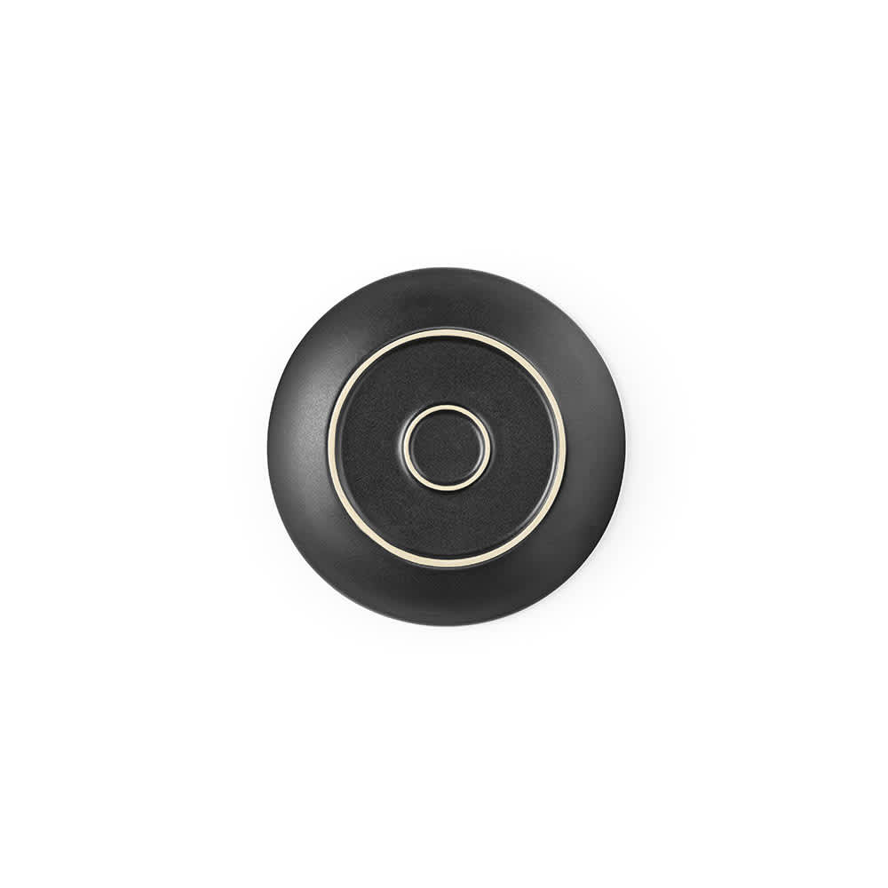 A ceramic dessert plate with a matte black finish and a decorative circular design. Made in Portugal.