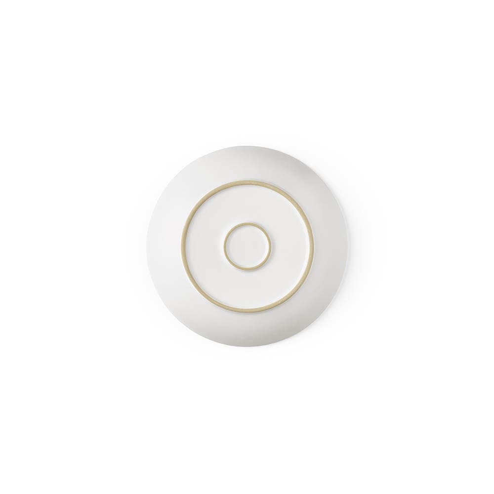 A ceramic dessert plate with a matte white finish, featuring gold circular patterns. Made in Portugal.