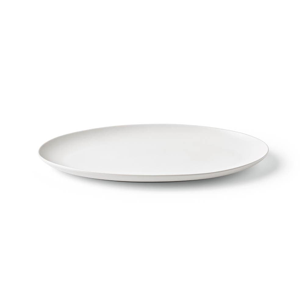 A white ceramic platter with a matte finish, featuring a simple, elegant design. Made in Portugal.
