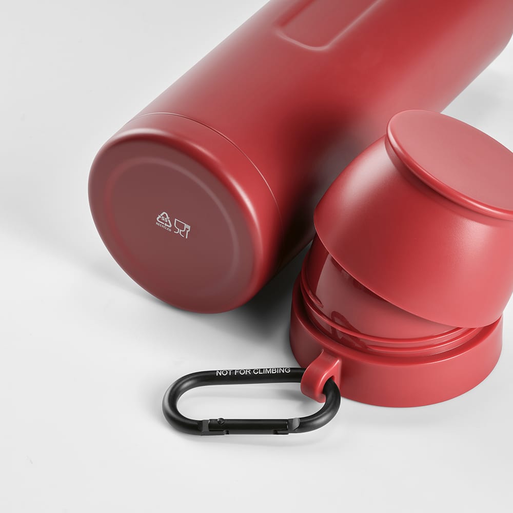 A drink bottle in red with two cups and a black carabiner. Includes a logo on the bottle.