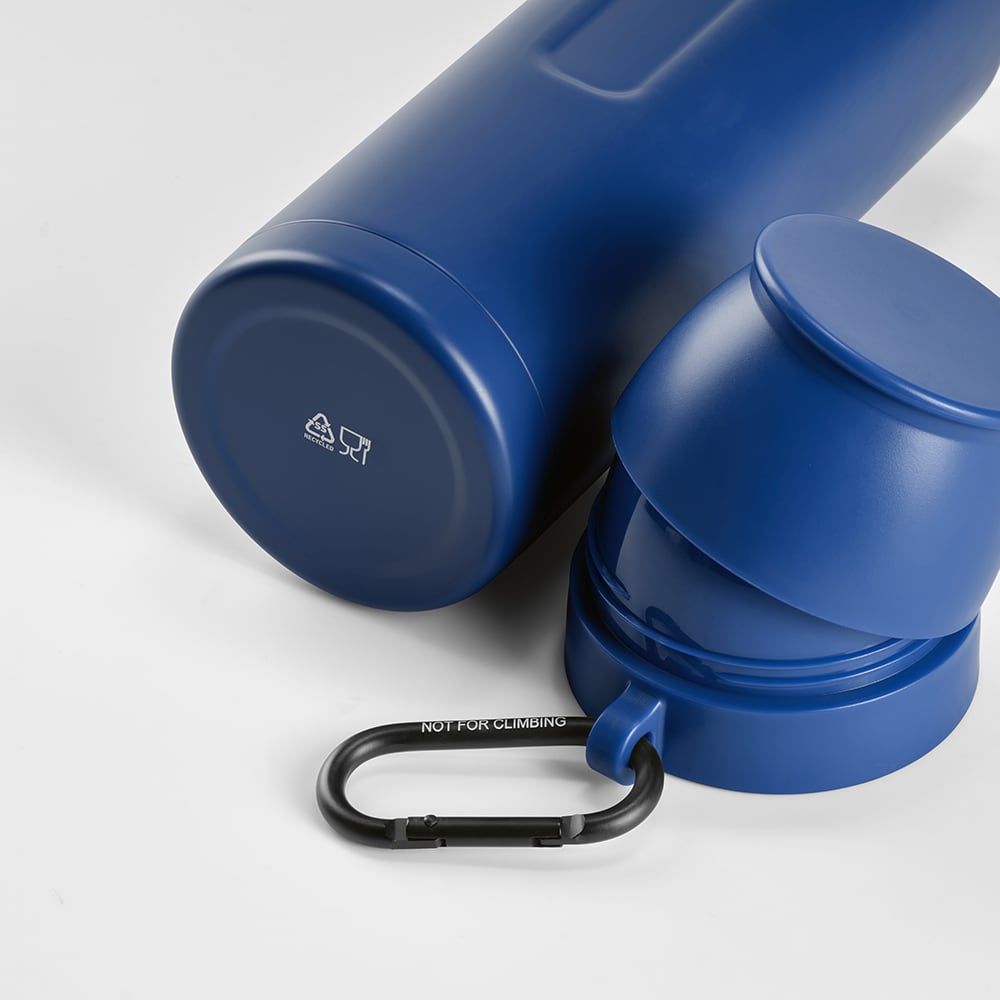 A drink bottle in a deep blue colour, with two cups and a black carabiner. It features a logo.