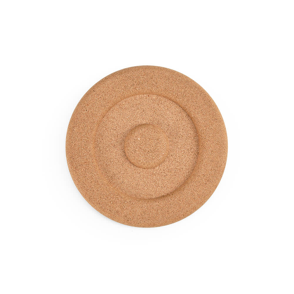 A round cork trivet with concentric rings, showcasing a natural, light brown colour and a textured surface.
