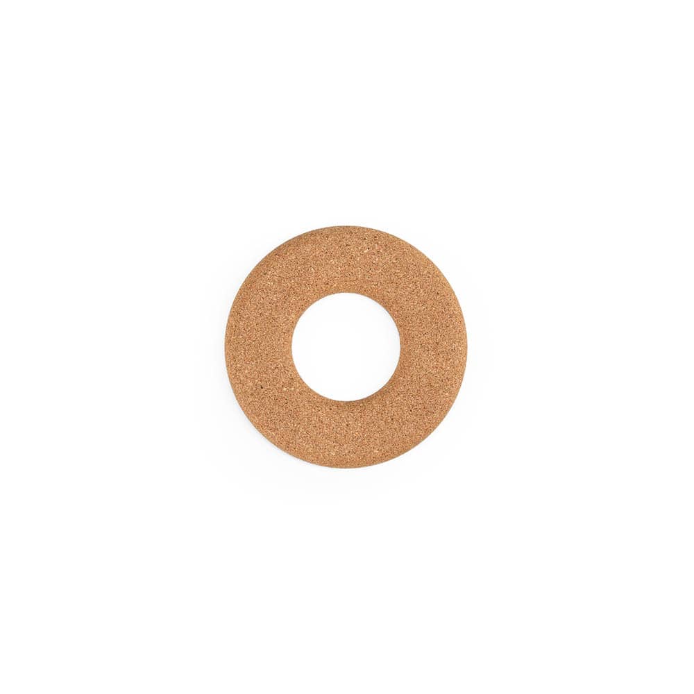 A round cork trivet with a central hole, featuring a natural cork finish. It is made in Portugal.
