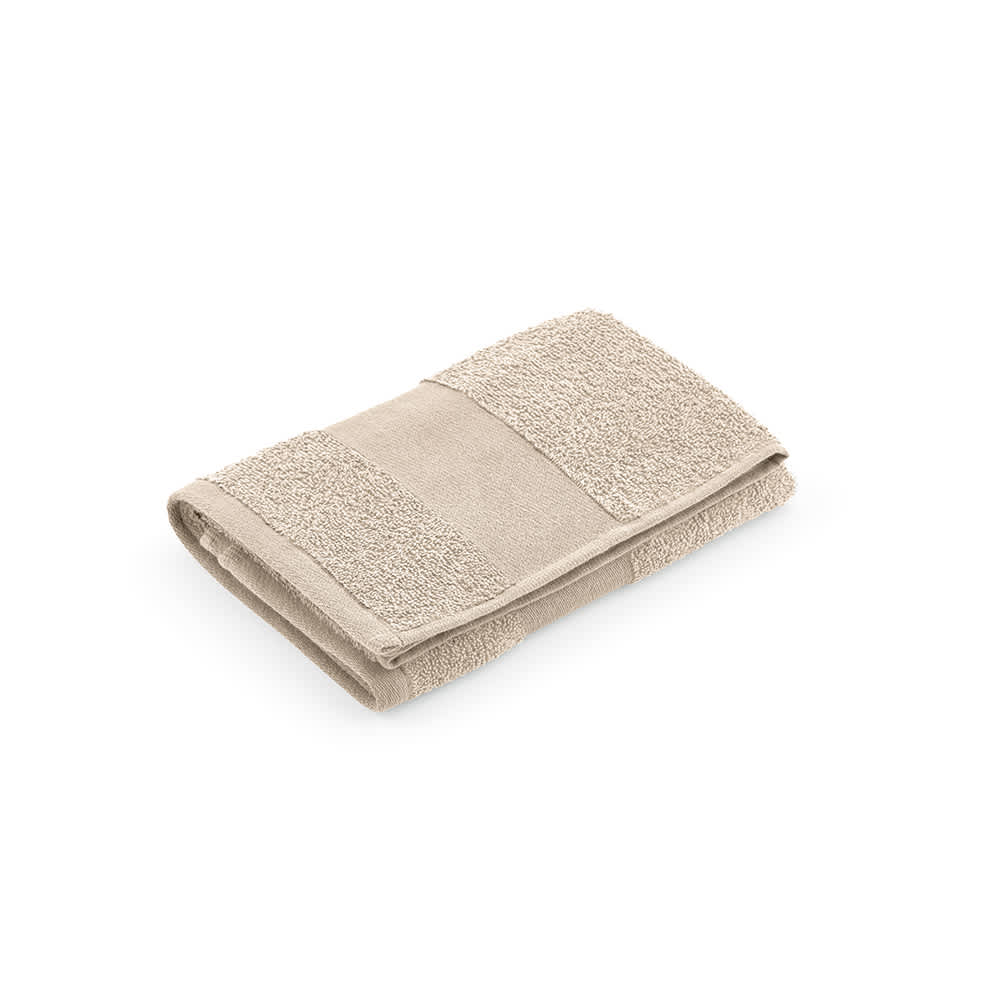 A folded beige towel made of cotton, featuring textured and smooth sections, with a logo visible.