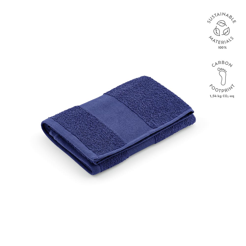 A navy blue towel made from 100% sustainable materials, featuring a textured design and a folded appearance.