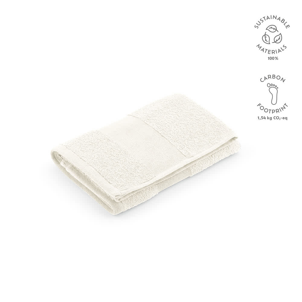 A folded white cotton towel labelled as Donatello M, featuring a logo, made in Portugal.