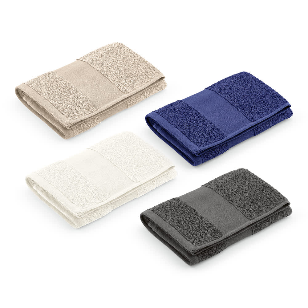 A collection of four folded towels in beige, white, navy, and grey, featuring a textured design and a logo.