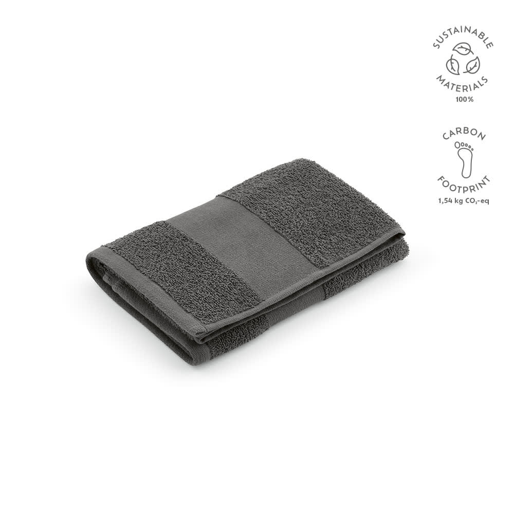 A folded grey towel made from sustainable materials, featuring a textured design and a logo.