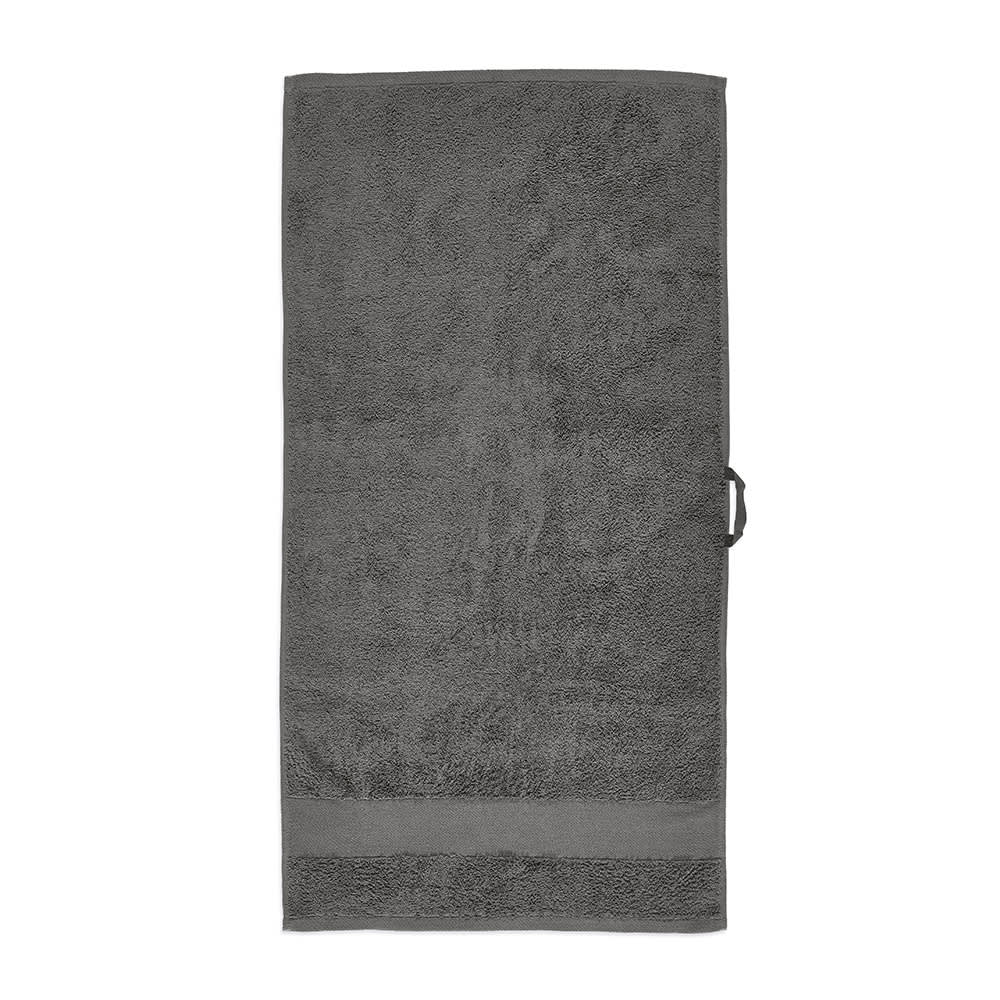 A grey cotton towel with a textured surface, featuring a simple design and a logo. Made in Portugal.