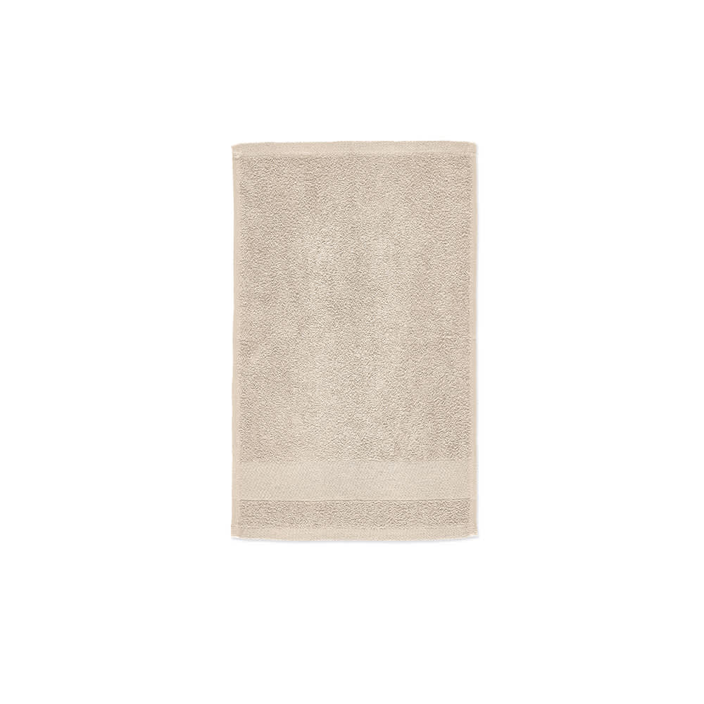 A light beige cotton towel with a textured surface, featuring a plain border. It has a brand logo at one end.