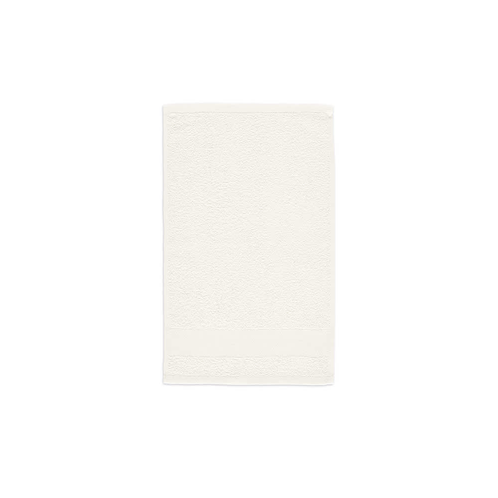 A soft, cream-coloured cotton towel with a textured surface and a plain border. It features branding.